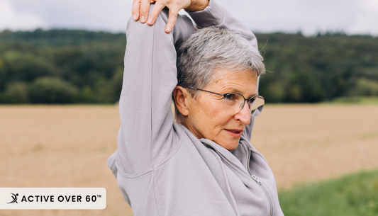 A person stretching their arms in a field