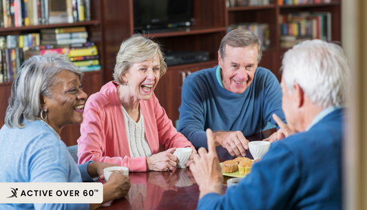a group of people sitting around a table having a conversation