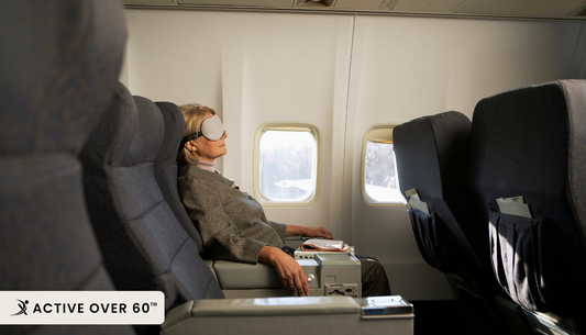 A person is sleeping on an airplane seat
