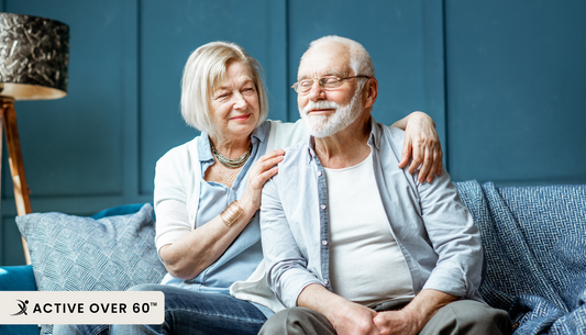 A man and woman sitting on a blue couch