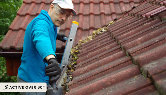 senior fixing the gutter