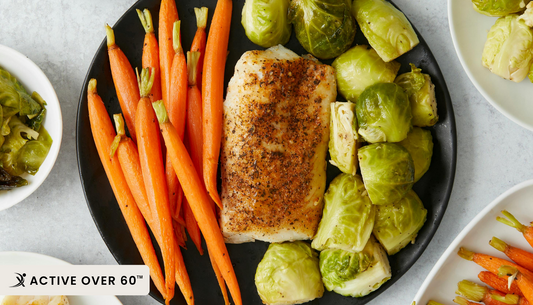 “Assorted high-fiber foods including whole grains, beans, lentils, chia seeds, fruits, and vegetables arranged on a wooden surface to promote digestive health.”