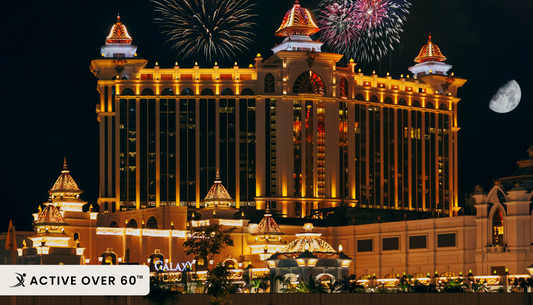 fireworks light up the sky over a casino in macau