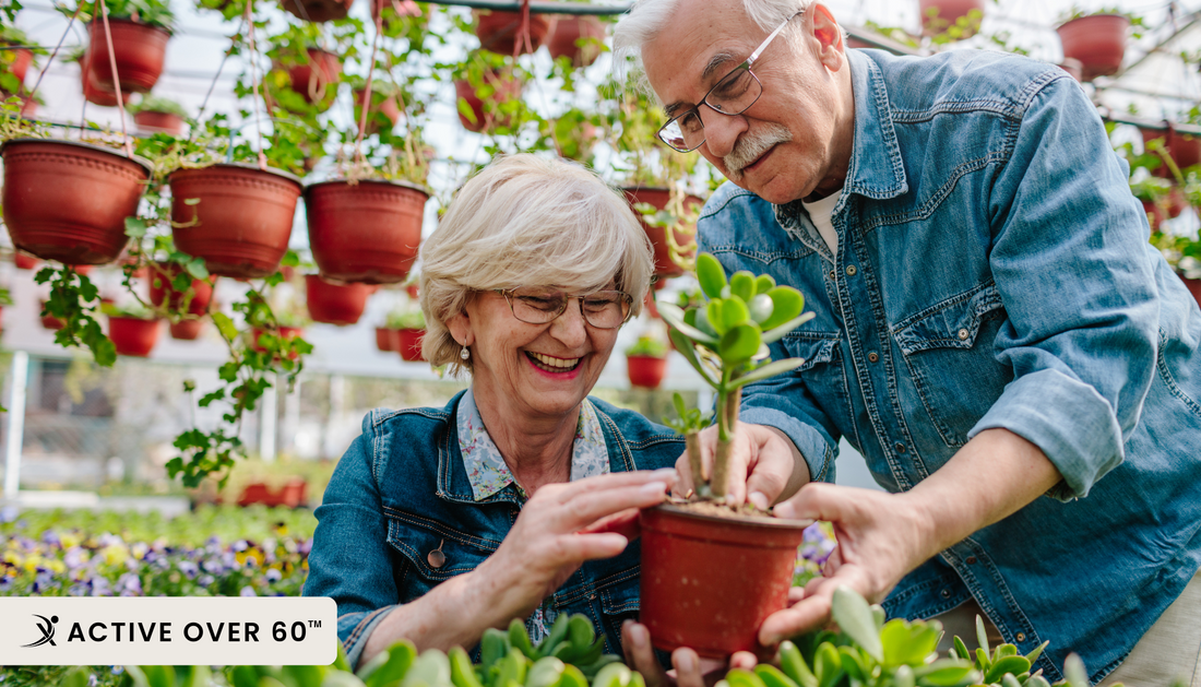 man and woman planting plants in greenhouse