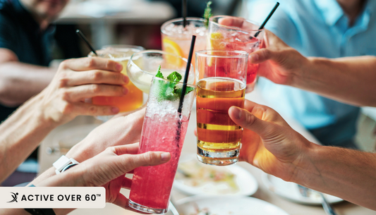 A group of people toasting with drinks at a restaurant