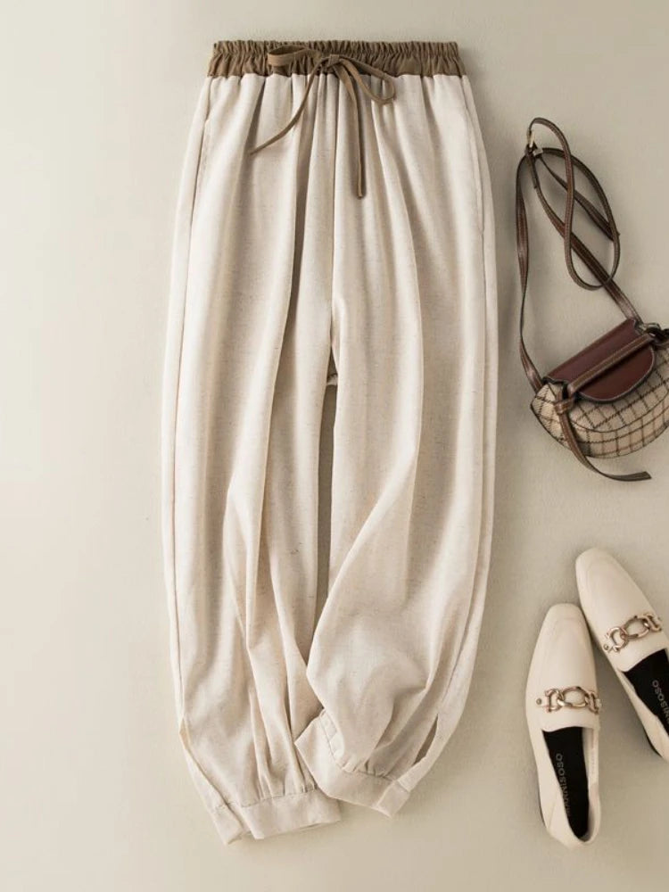 Beige pants with a handbag and shoes on a light background