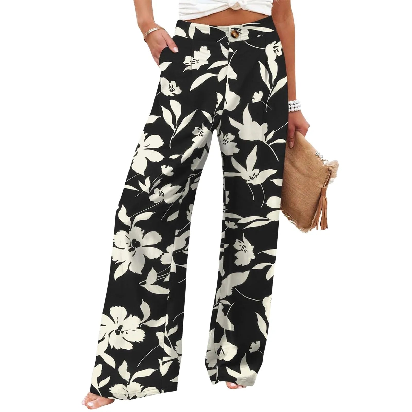 Black floral pants worn by a person on a white background