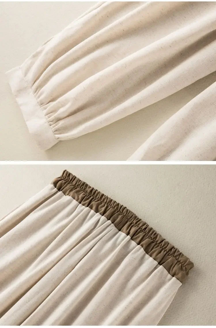 Close-up of beige fabric with brown trim on a plain background