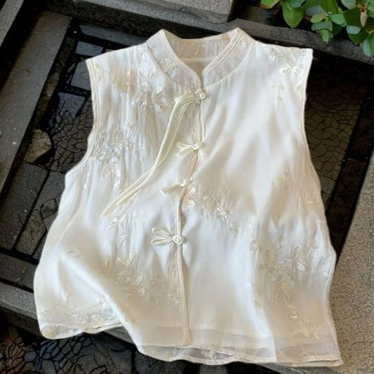 Lightweight embroidered sleeveless top with stand collar in beige, styled for active women over 40 during summer outings.
