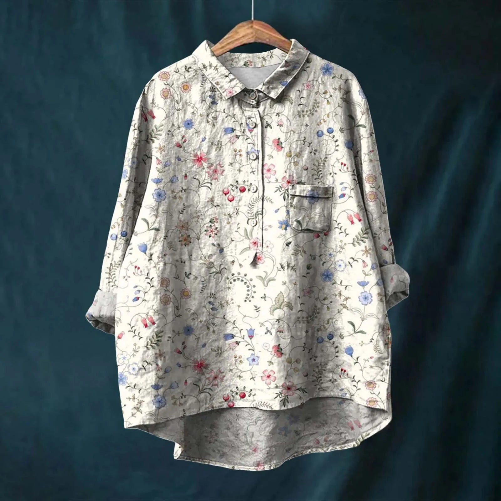 Floral patterned shirt on a wooden hanger against a dark blue background