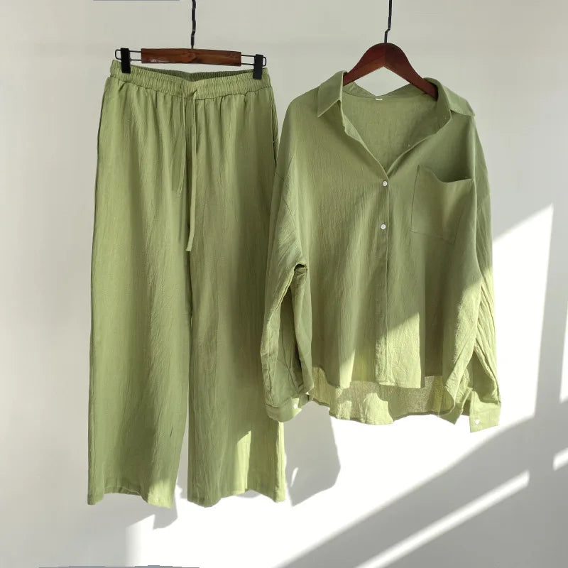 A two-piece clothing set featuring a button-up shirt and elastic-waist pants.
