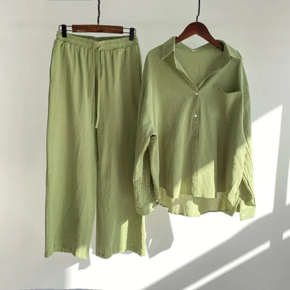 A two-piece clothing set featuring a button-up shirt and elastic-waist pants.
