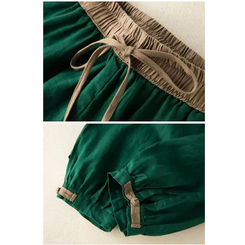 Green dress with brown trim and buttons on a white background