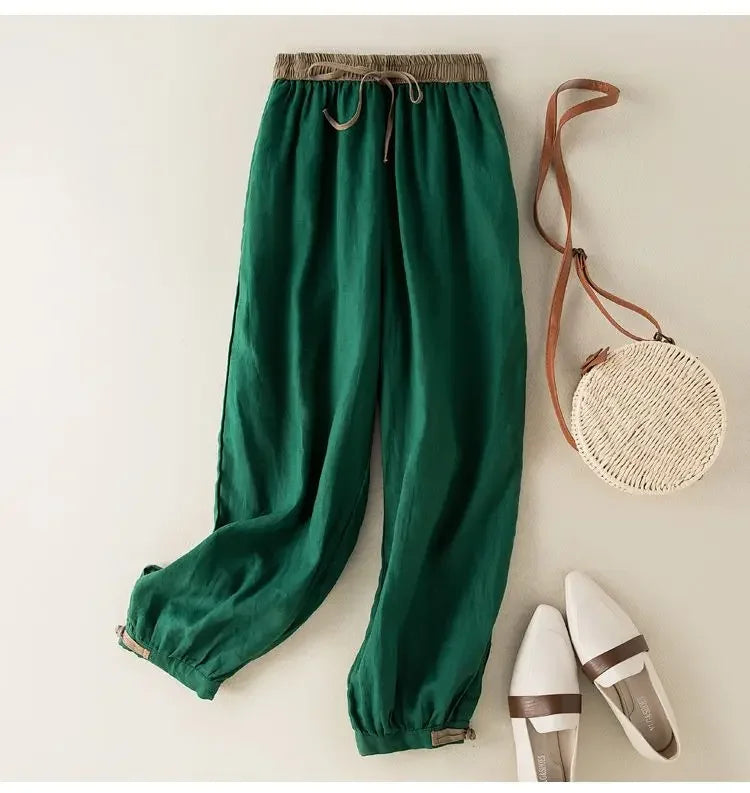 Green pants with a woven bag and white shoes on a light background