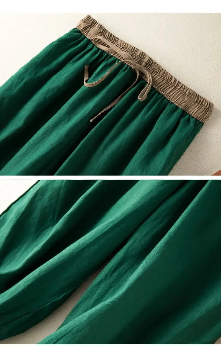 Green pants with a brown waistband on a white background