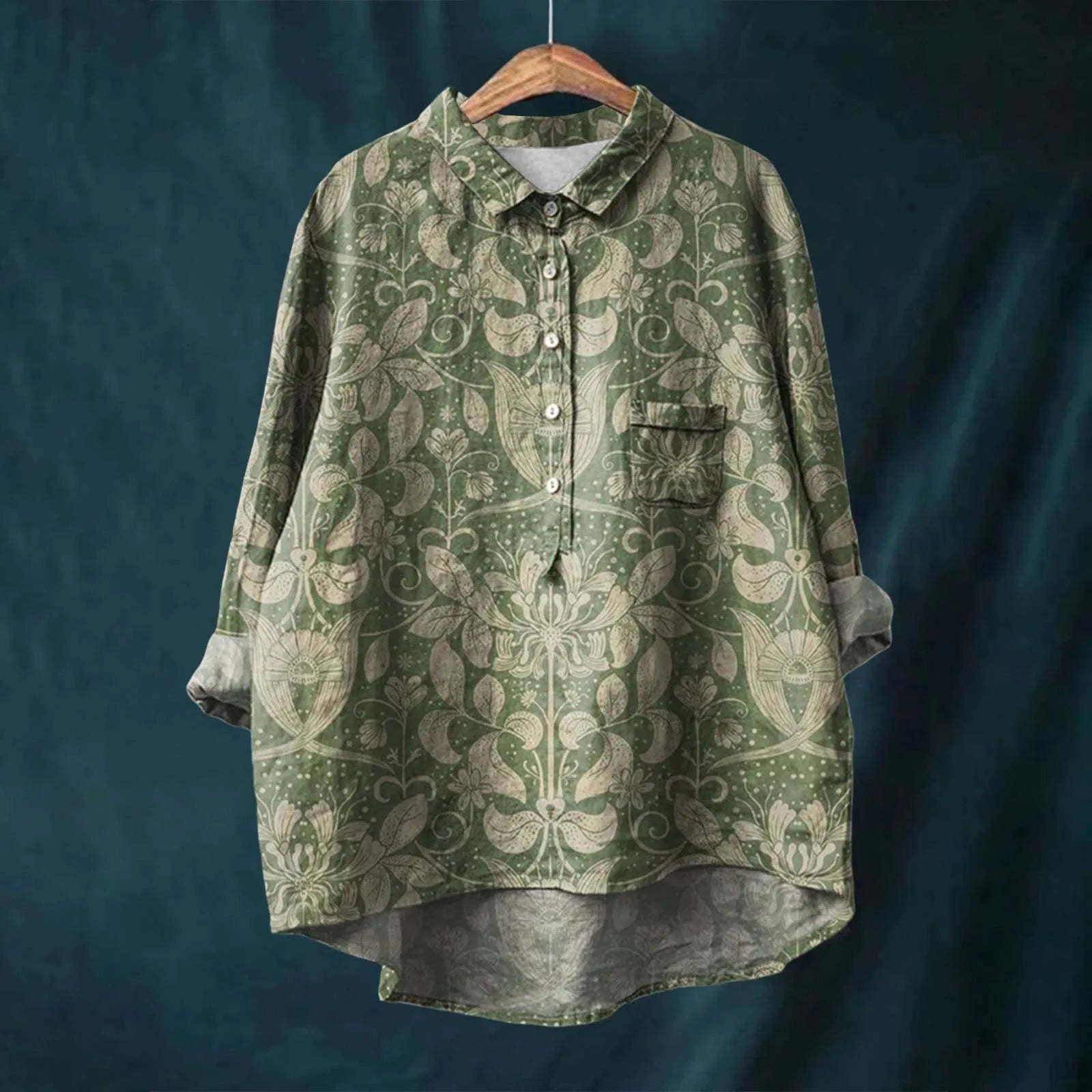 Green patterned shirt on a wooden hanger against a dark blue background