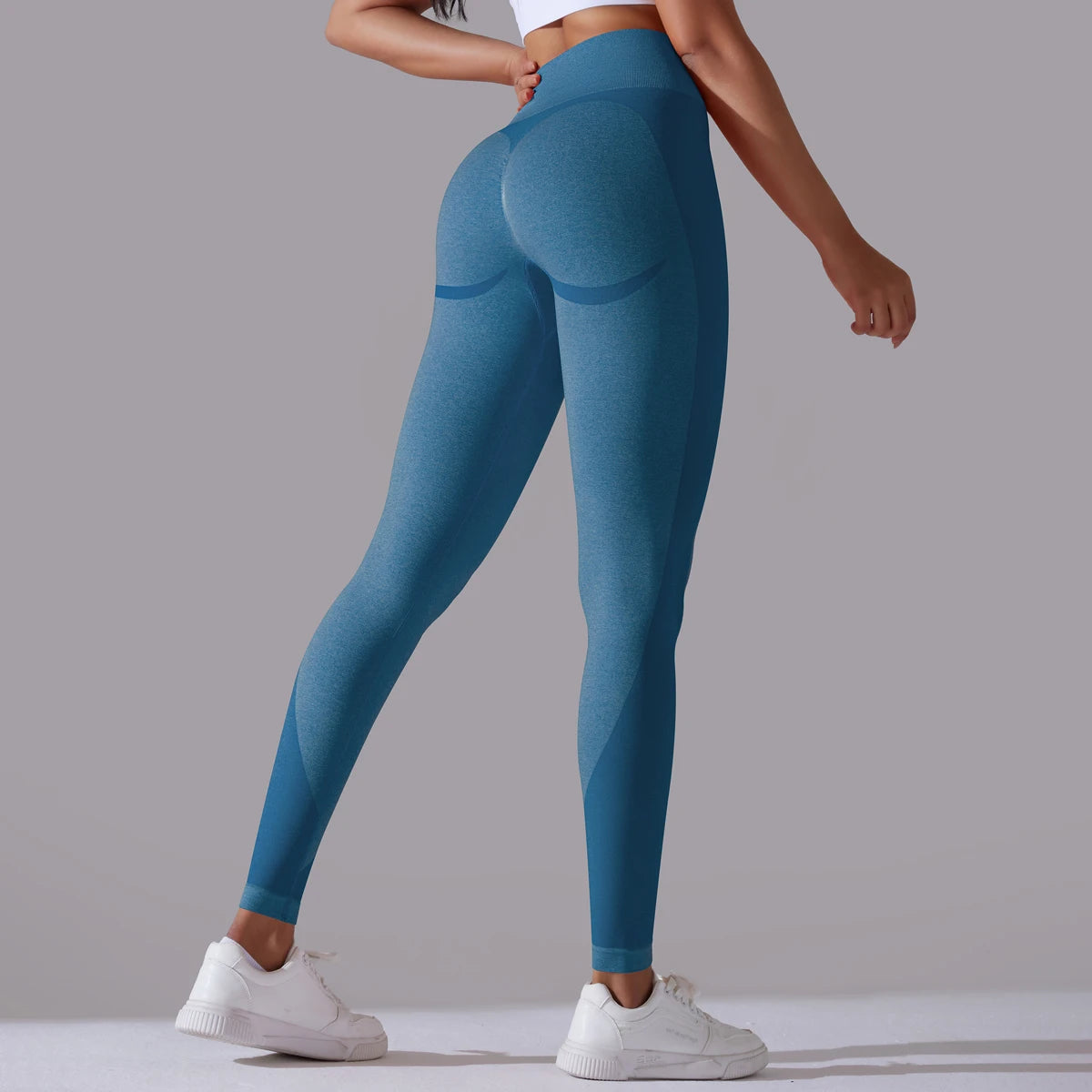 A pair of high-waist blue breathable nylon yoga leggings, featuring a wide elastic waistband and designed for active wear.