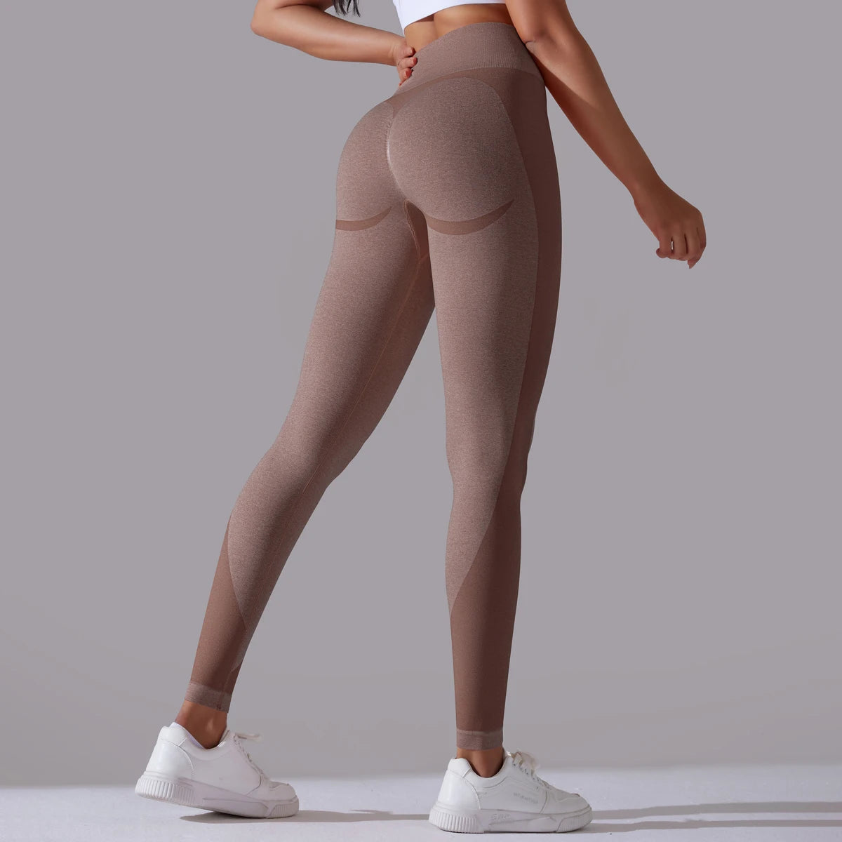 A pair of high-waist coffee breathable nylon yoga leggings, featuring a wide elastic waistband and designed for active wear.