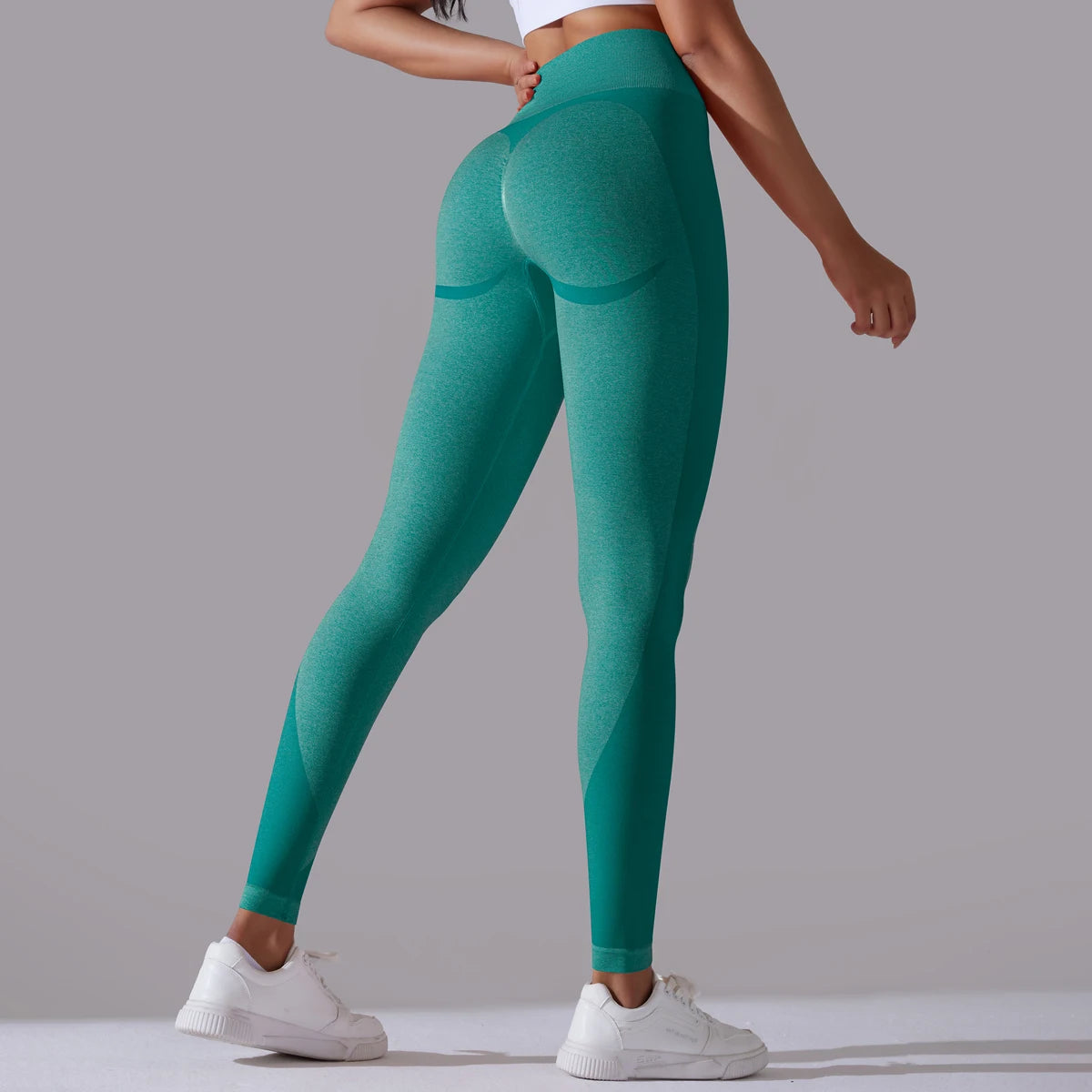 A pair of high-waist dark green breathable nylon yoga leggings, featuring a wide elastic waistband and designed for active wear.