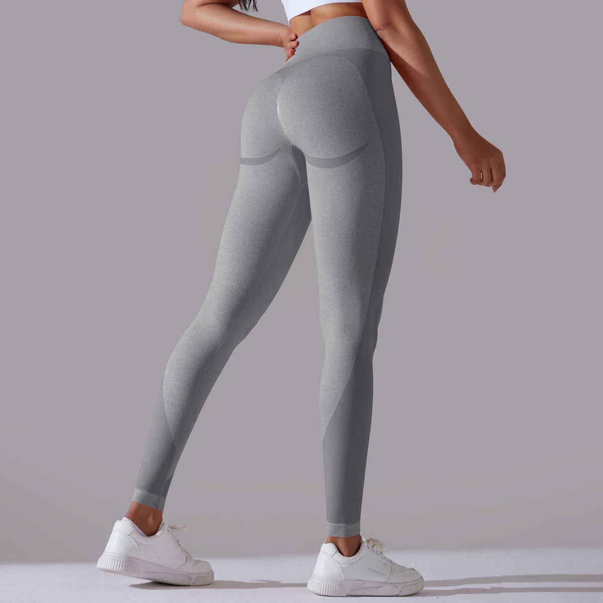 A pair of high-waist gray breathable nylon yoga leggings, featuring a wide elastic waistband and designed for active wear.