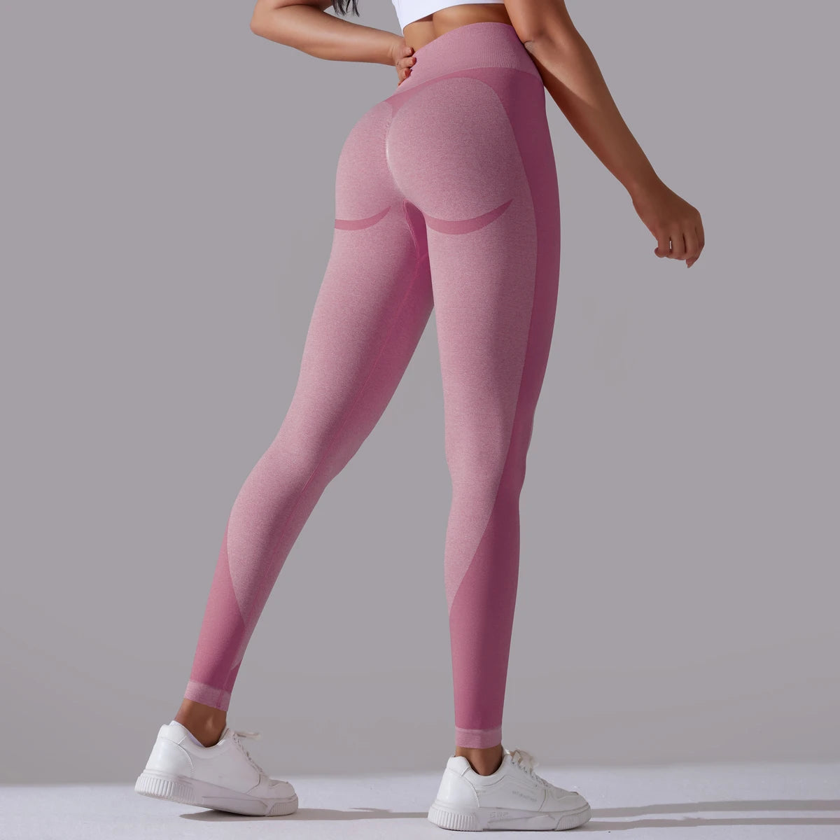 A pair of high-waist pale mauve breathable nylon yoga leggings, featuring a wide elastic waistband and designed for active wear.