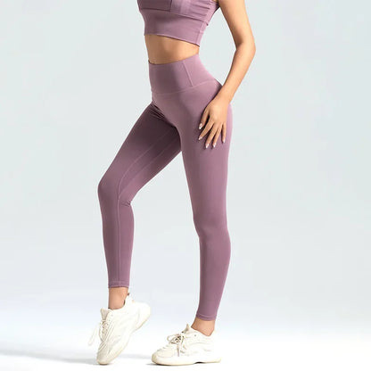 A woman wearing high-waist seamless booty-lifting yoga leggings in purple color, paired with a sports bra and white sneakers.