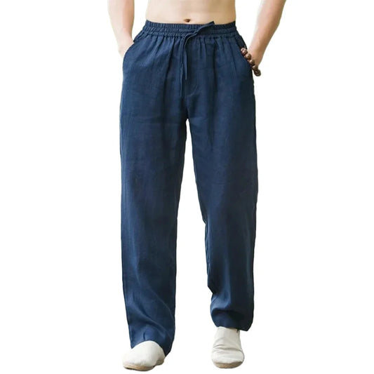 Man wearing loose cotton linen summer beach pants on a sunny boardwalk