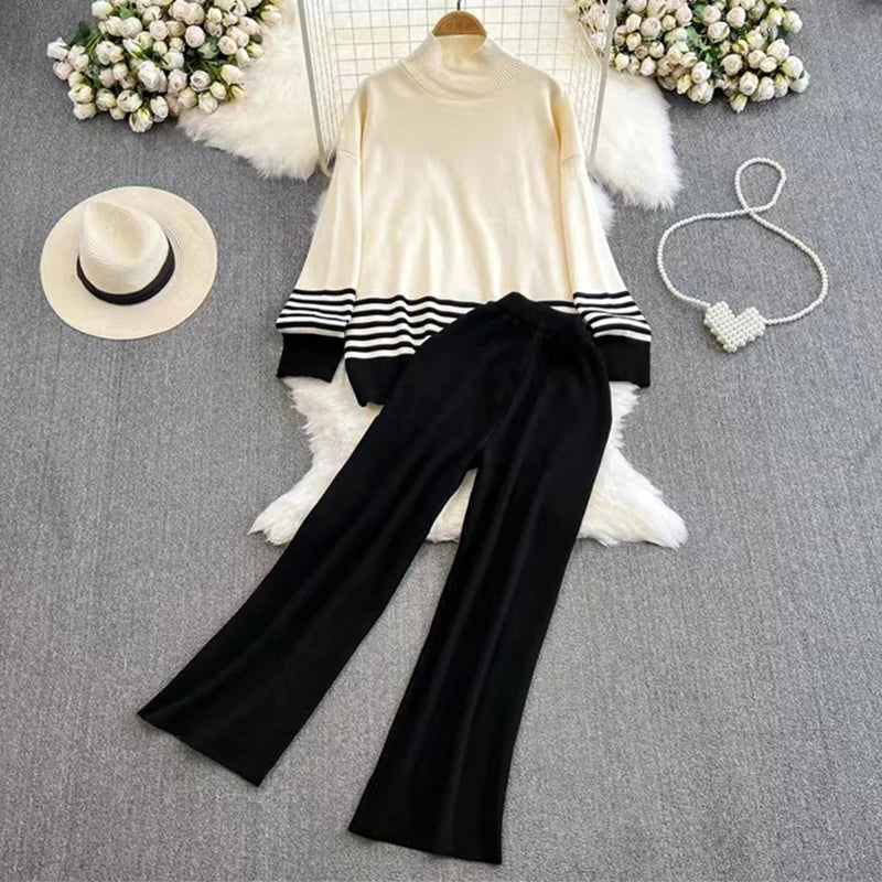 A loose knitted top in black with brown stripes on the sleeves and a pair of wide-leg pants in a matching brown color, displayed against a white background.