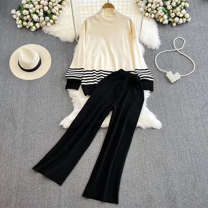 A loose knitted top in black with brown stripes on the sleeves and a pair of wide-leg pants in a matching brown color, displayed against a white background.