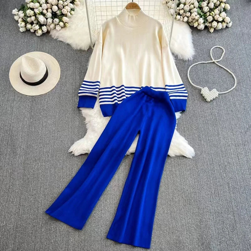 A loose knitted top in blue with brown stripes on the sleeves and a pair of wide-leg pants in a matching brown color, displayed against a white background.