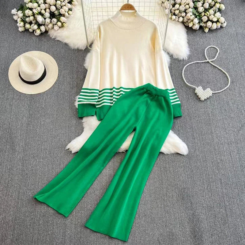 A loose knitted top in green with brown stripes on the sleeves and a pair of wide-leg pants in a matching brown color, displayed against a white background.