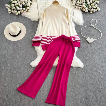 A loose knitted top in rose with brown stripes on the sleeves and a pair of wide-leg pants in a matching brown color, displayed against a white background.
