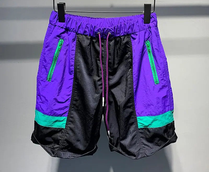 Purple and black shorts with green zippers on a hanger, featuring the brand 'S&L SHENG LDW'.