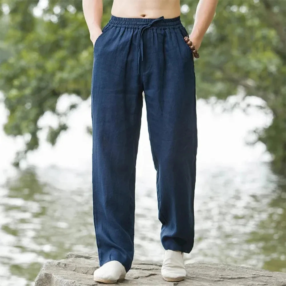 Man over 60 wearing lightweight linen pants on a garden bench