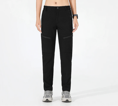 High-stretch women's hiking pants with breathable fabric, button fly closure, and moisture-wicking performance
