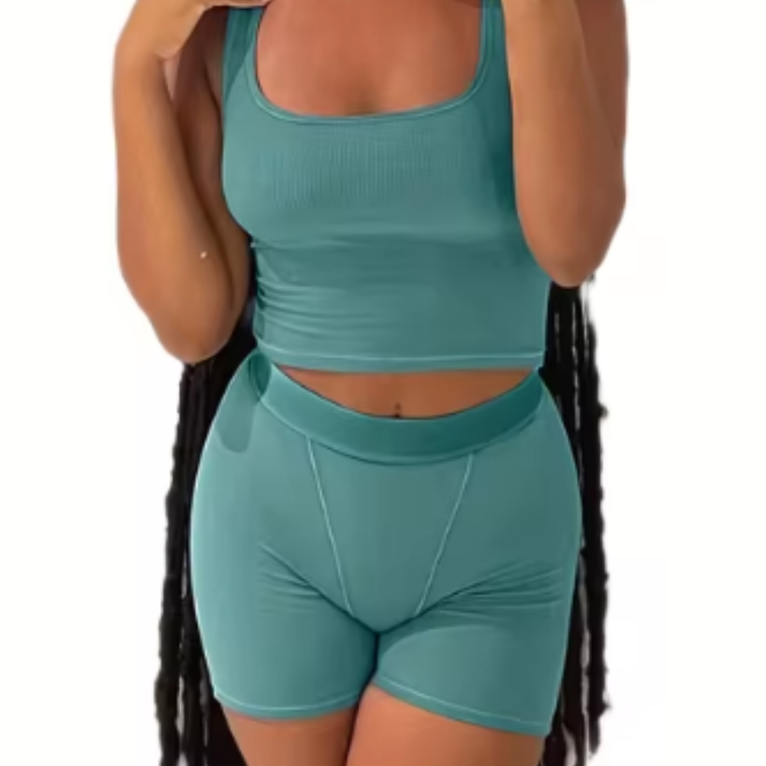 A woman wearing a white ribbed knit crop tank top and matching high-waisted leggings.