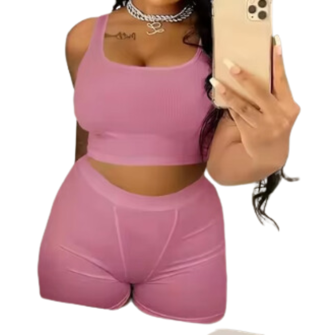 A woman wearing a white ribbed knit crop tank top and matching high-waisted leggings.
