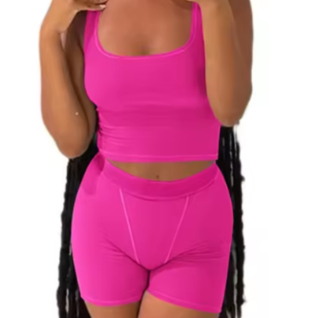 A woman wearing a white ribbed knit crop tank top and matching high-waisted leggings.