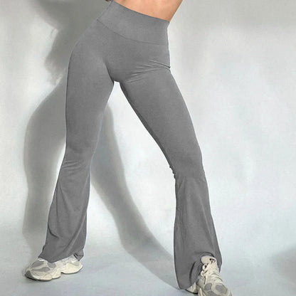 Flared yoga leggings in stretch fabric with mid-rise waistband and solid color design for active women