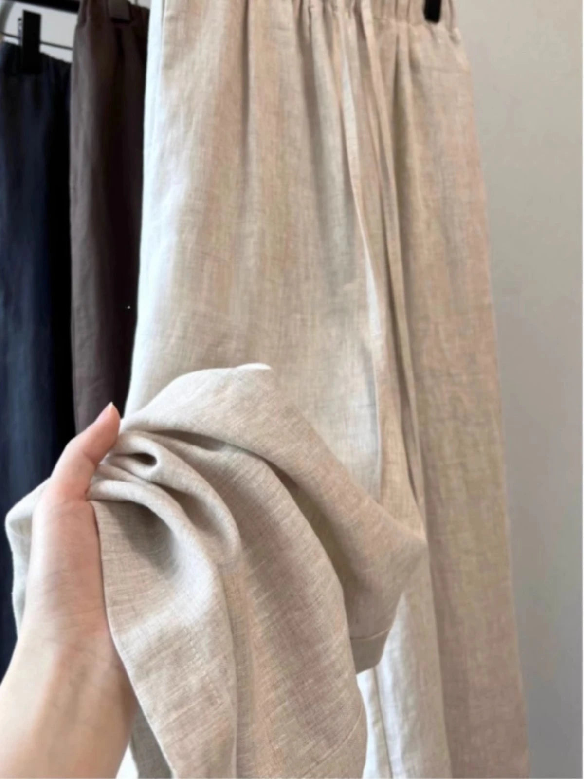 Lightweight breathable linen trousers with button-fly closure and high-rise waistband