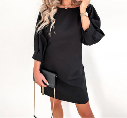 Three-quarter sleeve dress with bow accent, perfect for special events