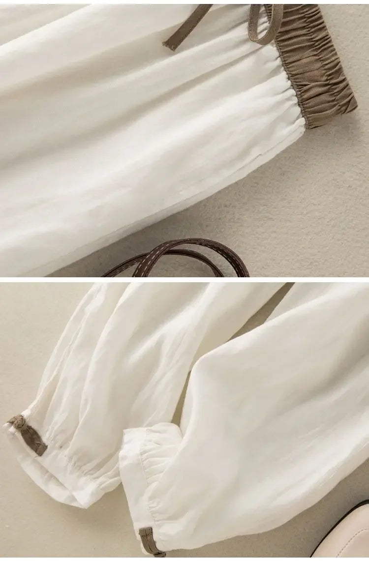 Simple solid white loose pants with breathable fabric and elastic waistband for unrestricted movement.