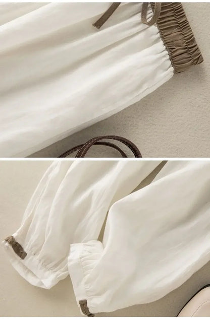 Simple solid white loose pants with breathable fabric and elastic waistband for unrestricted movement.