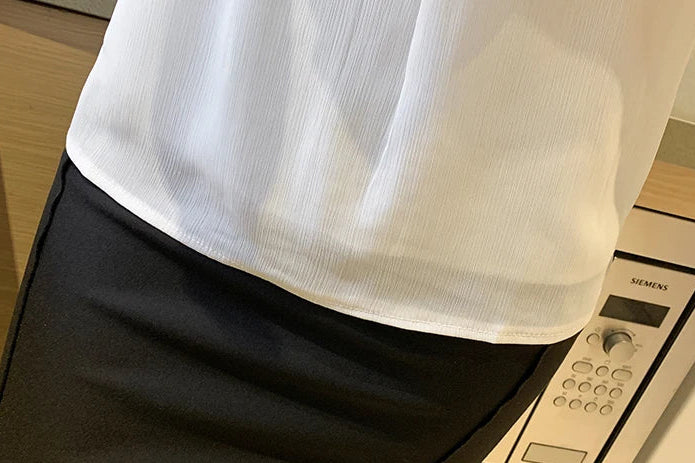 White chiffon top with stand-up collar, button accent, and lightweight feel for all-day comfort.