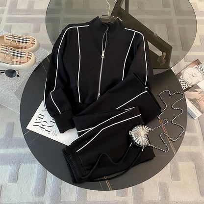 A Striped Contrast Sweatshirt and Pants Set for adults, displayed on a circular platform with a casual, sporty appearance in black color