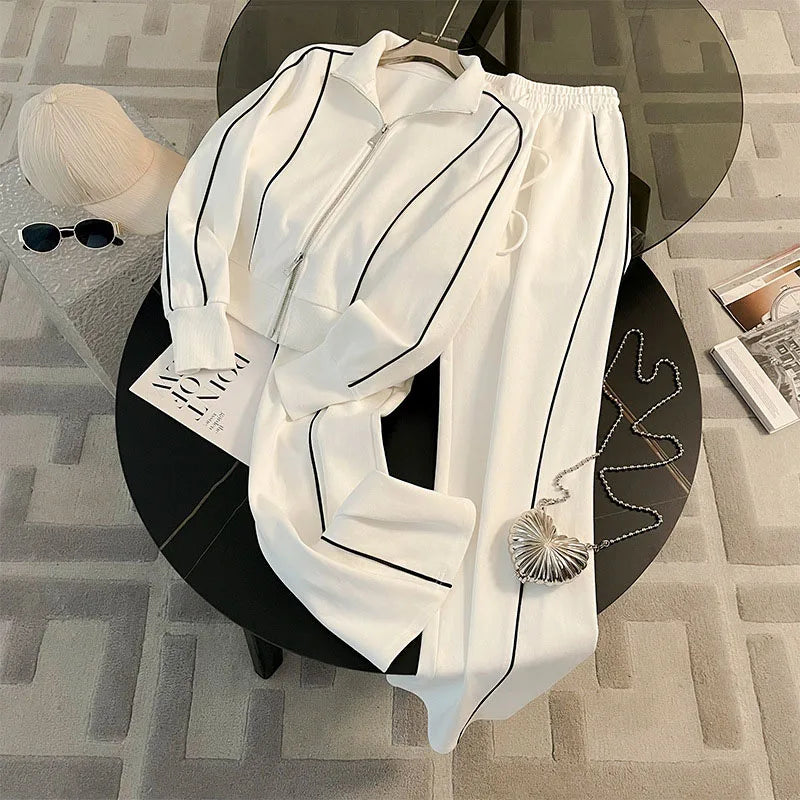 A Striped Contrast Sweatshirt and Pants Set for adults, displayed on a circular platform with a casual, sporty appearance in white color