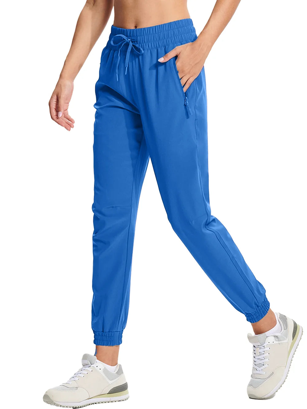A pair of bright blue athletic pants with an elastic waistband and drawstring, featuring side pockets and a full-length design.