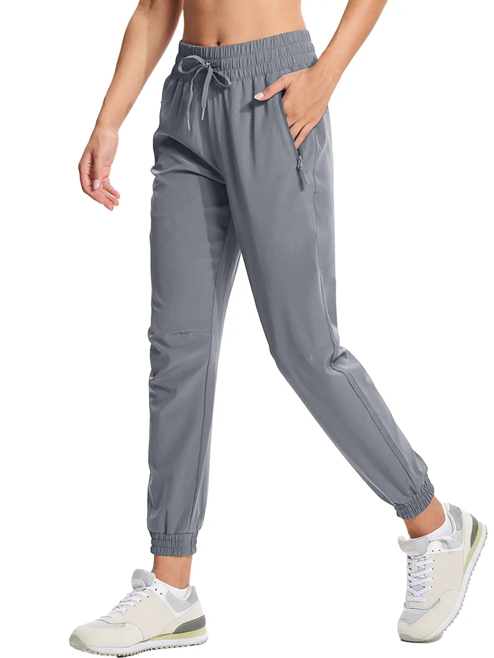 A pair of light gray athletic pants with an elastic waistband and drawstring, featuring side pockets and a full-length design.