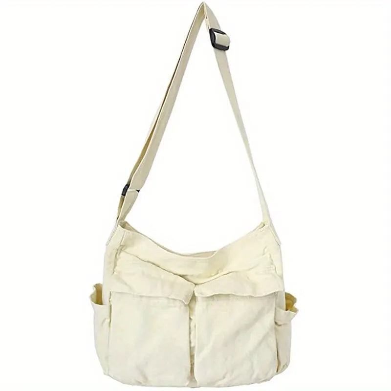 Organized items in the well-designed compartments of the canvas crossbody bag.