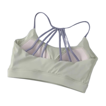 A collection of four women's cross-back yoga fitness bras in  back view displayed against a white background.